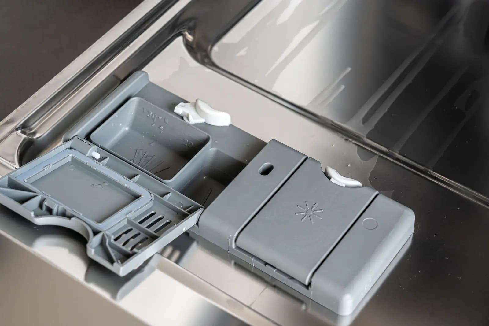 Dishwasher detergent dispenser on the inner door with soap residue