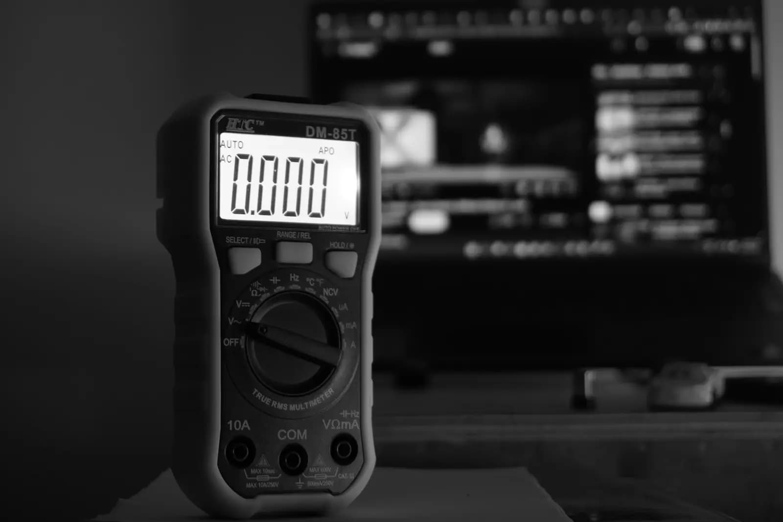 Digital multimeter on a dark workbench